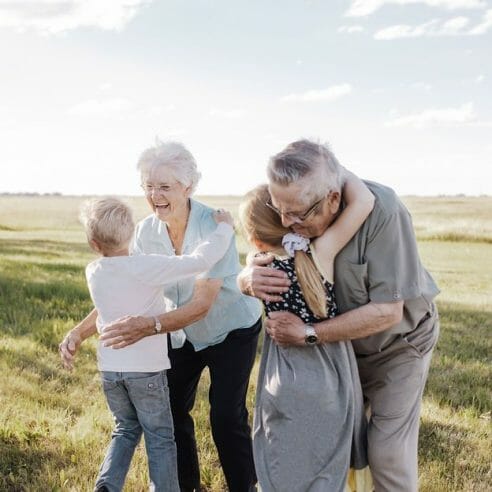Grandparents and grandchildren embracing